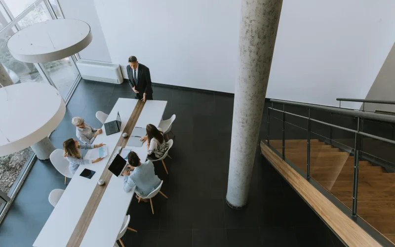 Aerial view at group of business people working together and preparing new project on a meeting in the office