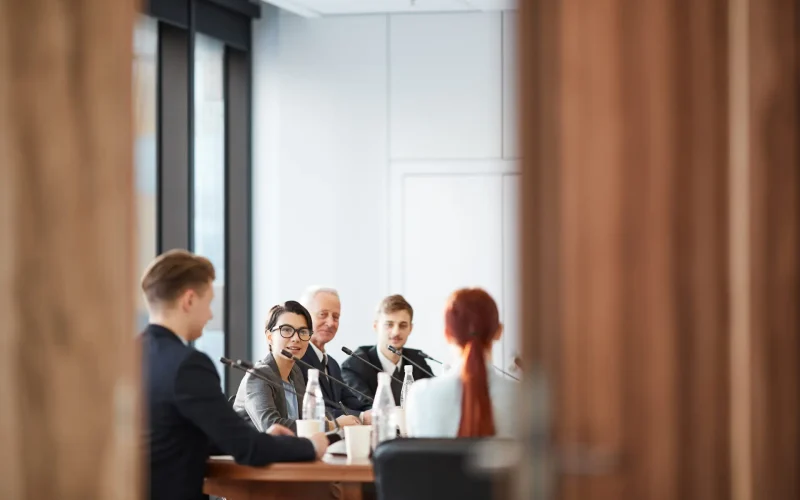 View of business meeting in conference room through open door, copy space
