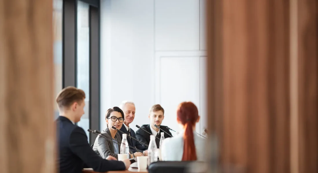 View of business meeting in conference room through open door, copy space